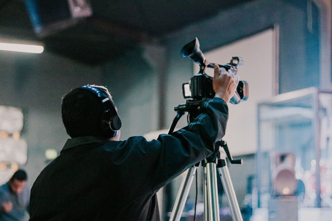 Camera operator adjusting framing through the viewfinder