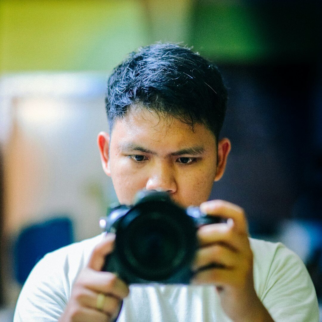 Portrait of a senior camera operator holding a professional camera